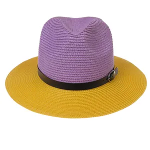 Detail of two-tone woven straw hat with purple crown, yellow brim and leather buckle strap