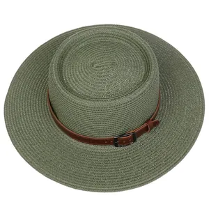 Detail of sage green straw hat featuring a woven texture and brown faux leather belt strap