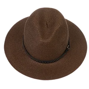 Detail of dark brown Panama straw hat with black leather band and silver metal studs