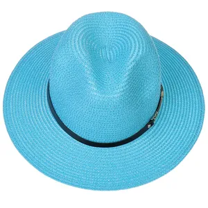 Détail du chapeau Panama bleu vif avec texture tissée et ruban en cuir noir à rivets