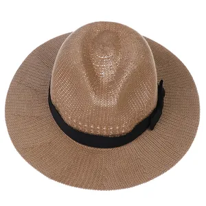 Detailed top view of a brown woven straw fedora hat with a black ribbon bow