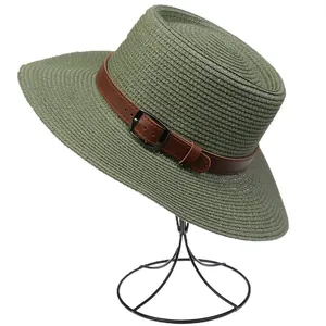 Detailed view of dark green straw fedora hat with brown faux leather belt buckle