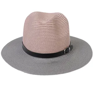 Close-up of pink and grey woven panama hat with black leather buckle strap detail