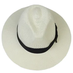 Detailed view of white woven straw fedora hat featuring a classic black grosgrain ribbon band