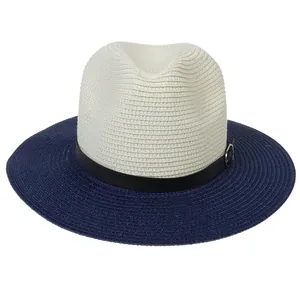 Detail of two-tone woven straw panama hat with black leather strap and metal buckle