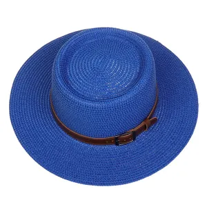 Detail of royal blue woven straw sun hat featuring a brown leather belt with black metal buckle
