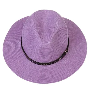 Top view of light purple wide-brim straw hat with black studded leather belt and buckle