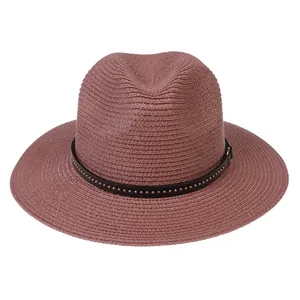 Close-up of woven straw fedora hat with brown PU leather band and silver metal rivets