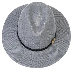 Macro shot of gray breathable woven fedora texture with black rope and wooden heart charm