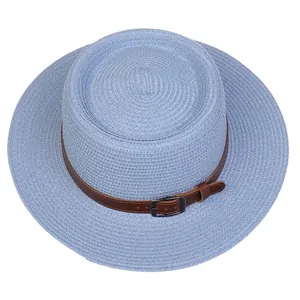 Close-up of light blue straw boater hat with a brown faux leather belt and metal buckle