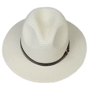 Detailed close-up of woven straw texture and leather band with metal rivets on panama hat