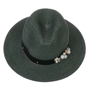 Détails de la texture du chapeau Panama vert foncé avec perles et décorations florales