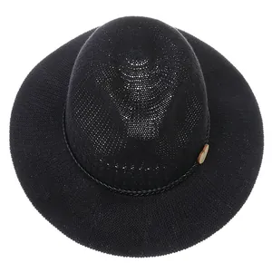 Top-down view of black woven fedora straw hat with decorative braided band and side buckle