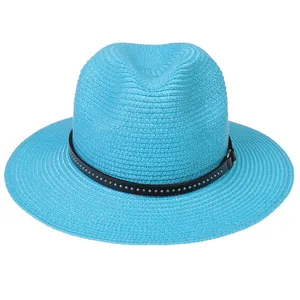 Detail of bright blue woven Panama hat showing the black studded band and texture