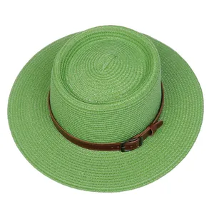 Detailed top view of a green straw boater hat with a brown faux leather belt and metal buckle