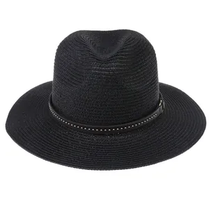 Detail of black woven straw fedora featuring a leather band with silver metal studs
