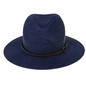 Detail of navy straw Panama hat with breathable weave and studded leather band decor