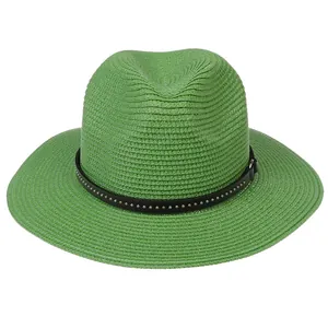 Detail of green straw fedora with black leather band and silver metal studs decoration