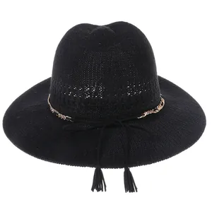 Detail of black straw fedora with gold metal chain and tassel ribbon decoration