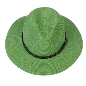 Macro detail of the woven grass texture and metal studs on a green Panama hat