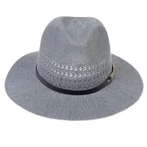 Detailed close-up of grey woven straw hat featuring hollow mesh and black leather band