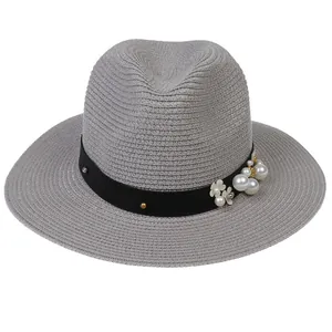 Détail du chapeau de paille Panama gris avec ruban fleuri et perles élégantes