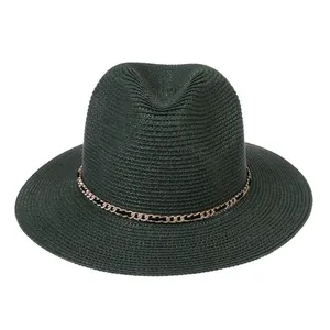 Detail of dark green woven straw hat featuring a stylish gold chain band accent