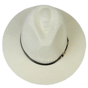 Close-up of cream straw fedora hat featuring breathable weave and black rivet band