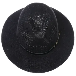 Top view of a black woven fedora hat featuring a fine mesh texture and golden buckle detail