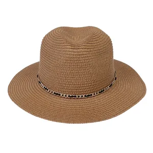 Detailed close-up of woven khaki straw texture and decorative gold chain on Panama hat