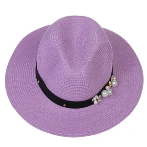 Détail du chapeau Panama violet clair avec ruban noir et accents de fleurs en perles