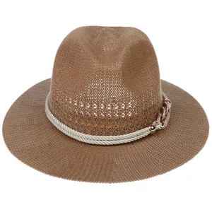 Detail of a brown woven sun hat featuring a cream twist rope and gold chain buckle link