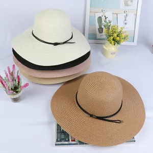 Selection of wide-brim straw hats in various colors with woven decorative bands