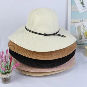 Detailed stack of five colorful straw sun hats with black decorative bands for summer