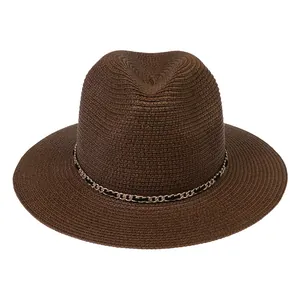 Detail view of dark brown straw Panama hat with elegant gold chain and woven texture