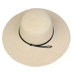 Detail of wide brim straw hat with spiral weave texture and black adjustable cord
