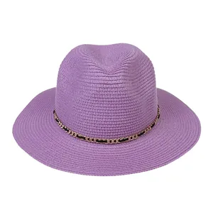 Detailed close-up of lavender straw Panama hat with elegant gold metal chain trim