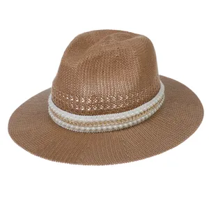 Detail of a brown woven straw fedora featuring a decorative pearl and gold chain band