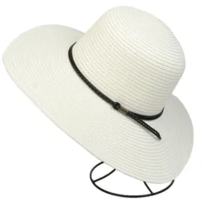 Detail of wide brim straw hat with spiral weave texture and black decorative rope band