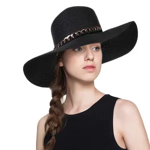 Chic black wide brim straw sun hat featuring a decorative rose gold metal chain trim