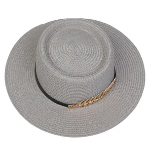 Detailed top view of grey woven boater hat with black ribbon and gold leaf chain decoration