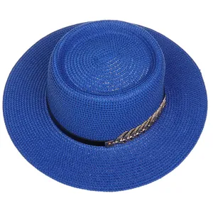 Detailed top view of a blue straw boater hat featuring gold leaf accents and black ribbon