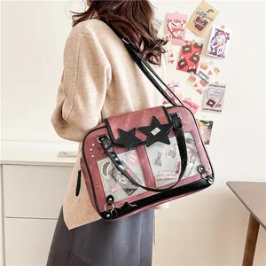 Retro pink ita bag with clear window and star patches worn by a model in a cozy room