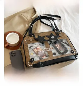 Detail of a brown PU leather ita bag featuring transparent windows and star accents