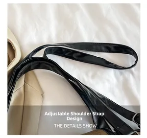 Detail of adjustable black PU leather shoulder strap with a sturdy metal buckle