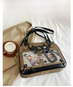Detail of a brown PU leather Ita bag with star accents and transparent windows for cards