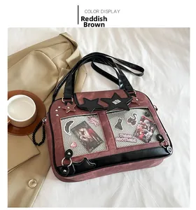 Detail of reddish brown Ita bag with transparent windows and star leather patches