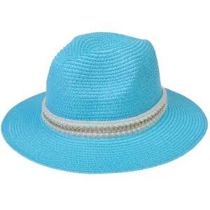 Détail du chapeau Panama bleu vif orné de perles blanches et d'une chaîne dorée élégante