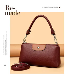 Elegante bolso de piel burdeos para móvil con solapa marrón y asa superior resistente