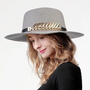 Elegant grey flat top straw hat with pearl floral detail and gold accent for beach sun protection